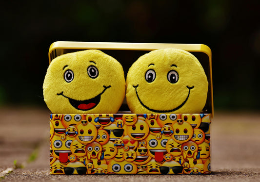 Stuffed smiley faces in a box